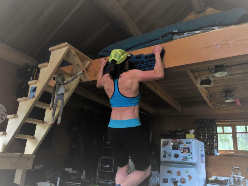small cabin living getting exercise on a hangboard