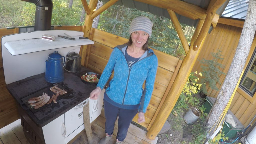 standing next to food cooking on a cook stove